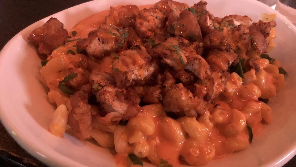 Dynamite Mac N' Cheese (Spicy) · Our famous bier cheese Mac n' Cheese topped with crispy chicken tenders tossed in Nashville seasoning, fresh jalapeños, cilantro, and dynamite sauce.