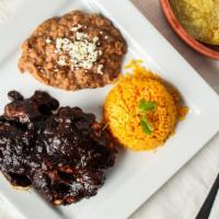 Mole Con Pollo · Authentic and traditional homemade chicken mole. Served with rice, refried beans, and tortil...