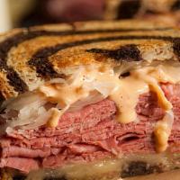 The Reuben · Our Reuben starts with sautéed onions and garlic, corned beef, sauerkraut, The King's white ...