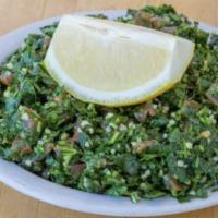 Tabouleh Salad · Fresh chopped parsley, diced tomatoes, onions, served with lemon.