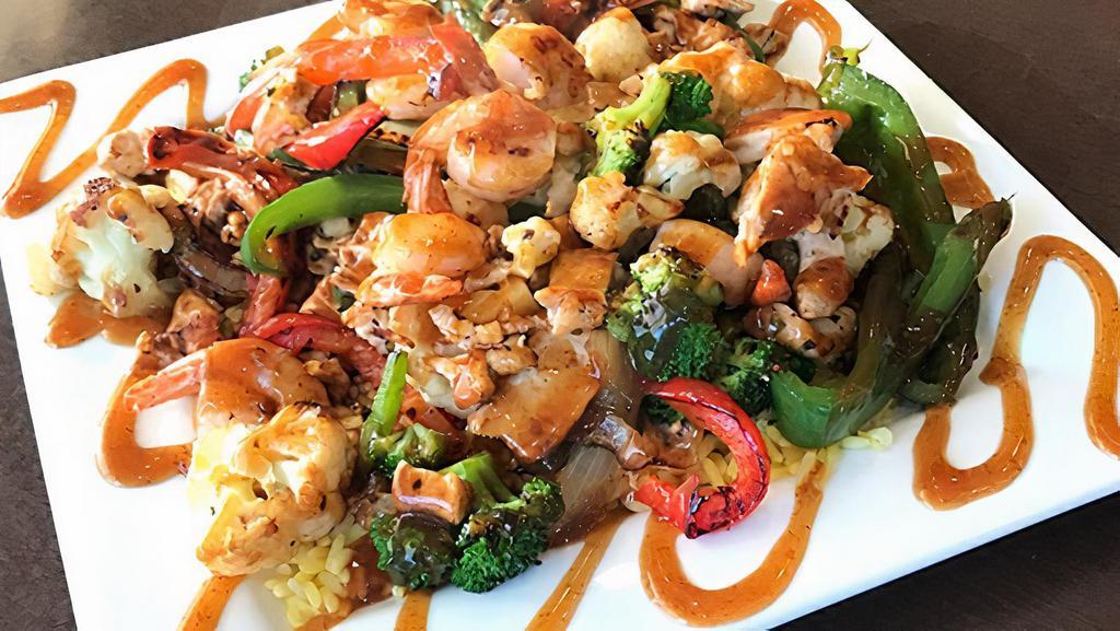 Maple Stir Fry · With seasoned vegetables, chicken and shrimp tossed over a bed of rice.