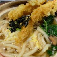 Nabe Yaki Udon · Japanese style noodle soup with shrimp tempura, egg, fish cake, vegetable, and scallop.