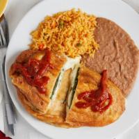 Chiles Rellenos · Two poblano peppers stuffed with cheese & topped with our traditional red sauce.