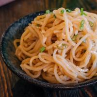 Garlic Noodles · Thin noodles sauteed with our soy-garlic sauce and garnished with green onion.