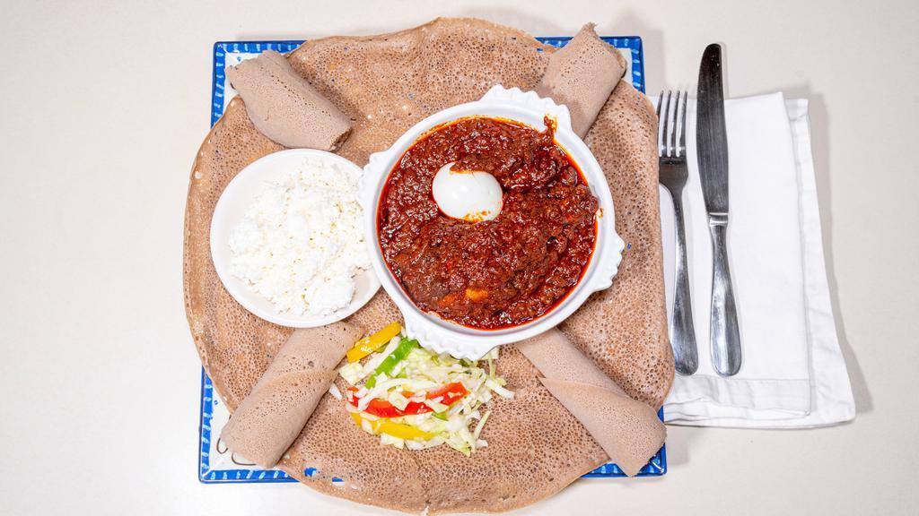 #26. Doro Wot · Chicken drumsticks simmered in a red turmeric sauce, seasoned with traditional spices and herbs and cottage cheese served on budenna (injera).