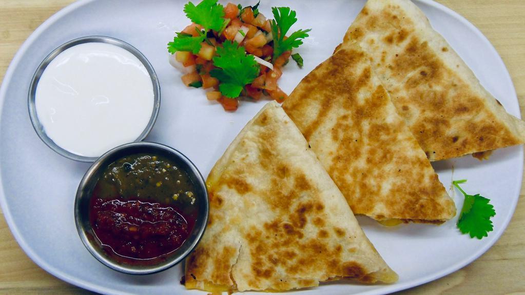 Meat + Cheese Quesadilla · Grilled tortilla filled with your choice of protein + mozzarella cheese with choice of salsa. Served with sour cream on the side.