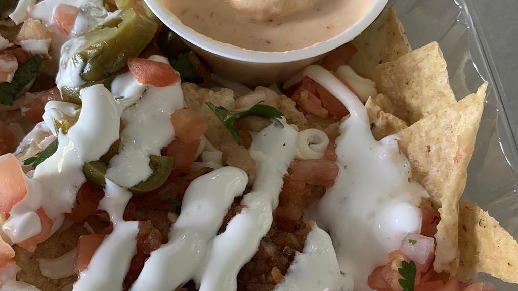 Cinco Nachos · Nachos topped with seasoned ground beef, queso cheese sauce, sour cream, pico, jalapeño and shredded mixed cheese with choice of salsa.