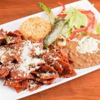 Chilaquiles Rojos Con 2 Huevos · Corn tortilla chips simmered in homemade red sauce and (2) eggs. Served with rice, beans, sa...