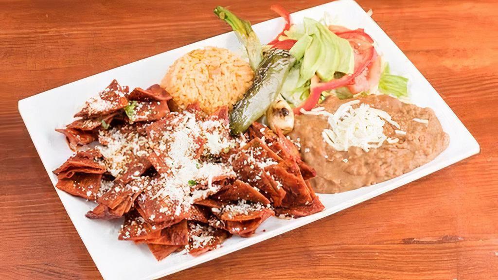 Chilaquiles Rojos Con 2 Huevos · Corn tortilla chips simmered in homemade red sauce and (2) eggs. Served with rice, beans, salad and avocado.