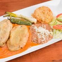 Chiles Rellenos En Salsa Ranchera · (2) poblano peppers stuffed with cheese, with homemade ranchero sauce. Served with rice, bea...