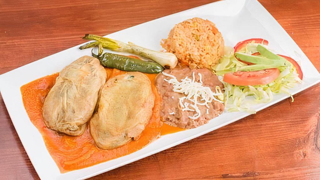Chiles Rellenos En Salsa Ranchera · (2) poblano peppers stuffed with cheese, with homemade ranchero sauce. Served with rice, beans, salad and avocado.