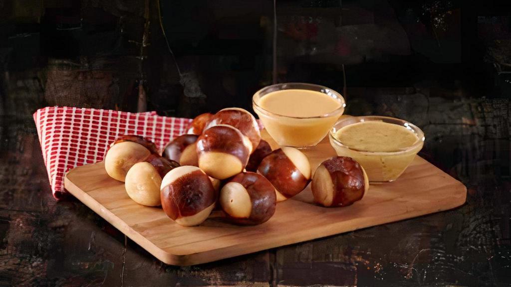 Pretzel Bites · flash fried and lightly salted. served with four cheese sauce and honey mustard