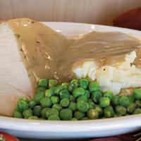Turkey Dinner · turkey breast served with mashed potatoes, gravy, stuffing, green peas, and cranberry sauce