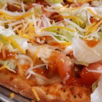 Taco Pizza · Beef or chicken, yellow onions, roma tomatoes, lettuce, taco sauce, Cheddar cheese.