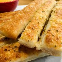 Cheese Bread · Freshly baked 16 pieces garlic cheese bread topped with mozzarella cheese and Romano cheese.