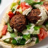 Ultimate Falafel Pita · Fresh falafel served in a pita with hummus, cucumber, tomato, lettuce, onions, french fries,...
