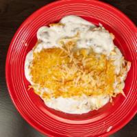 Stockyard Scramble · Biscuit topped with scrambled eggs hash browns and sausage gravy.