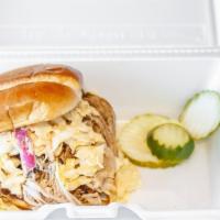 The Carolina · Our famous pulled pork smothered in our north Carolina vinegar sauce and topped with spicy s...