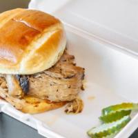 Pulled Pork · Pork shoulder dry-rubbed with our secret rub and slow smoked for hours served on a brioche b...