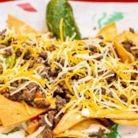 Nachos Supreme · Cheese topped with your choice of steak, chicken, al pastor or ground beef with beans, guaca...