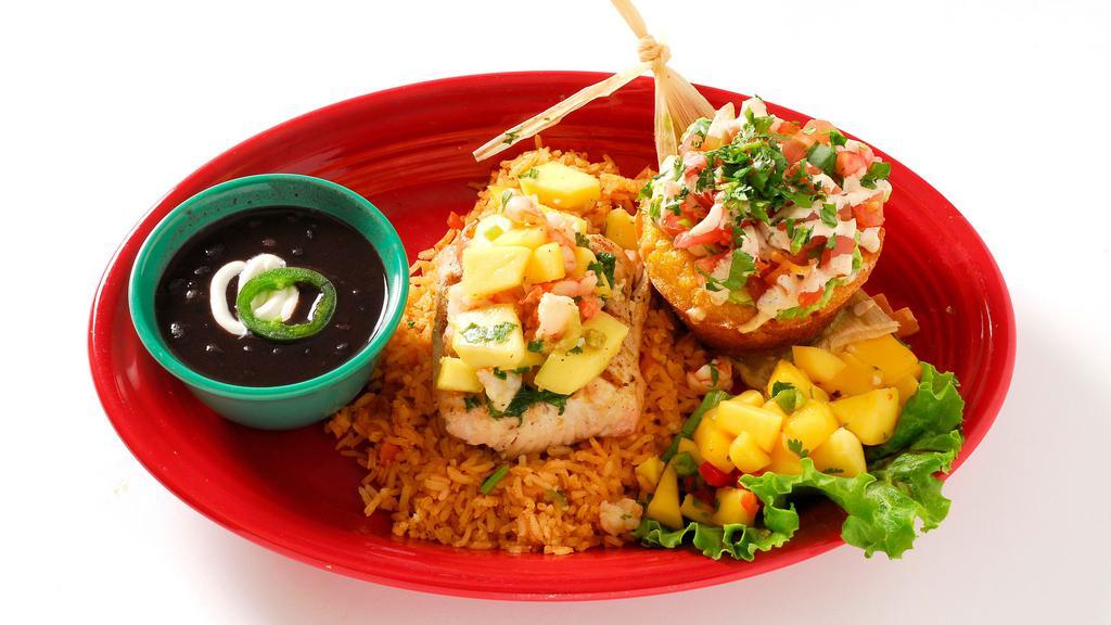 Mahi Mahi With Mango Shrimp Salsa · Perfectly seasoned and grilled Mahi topped with tasty mango shrimp salsa on a bed of rice.  Served with a sweet corn tamale cake and your choice of beans.
