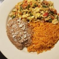 Huevos Ala  Mexicana · Eggs scrambled with chopped tomatoes, onions and peppers. Served with Mexican rice and refri...
