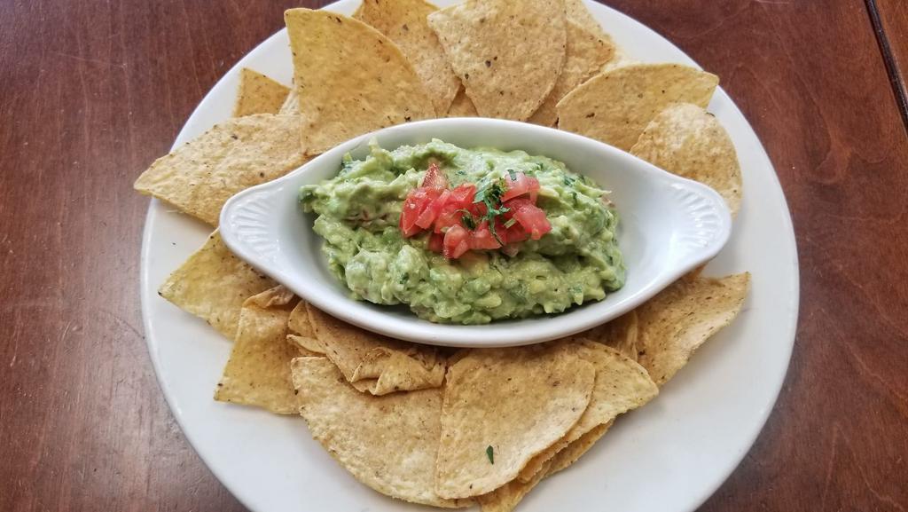 Guacamole W  Chips · Fresh hass avocado with onion, tomato, cilantro, jalapeño pepper and fresh lime. Served with tortilla chips.