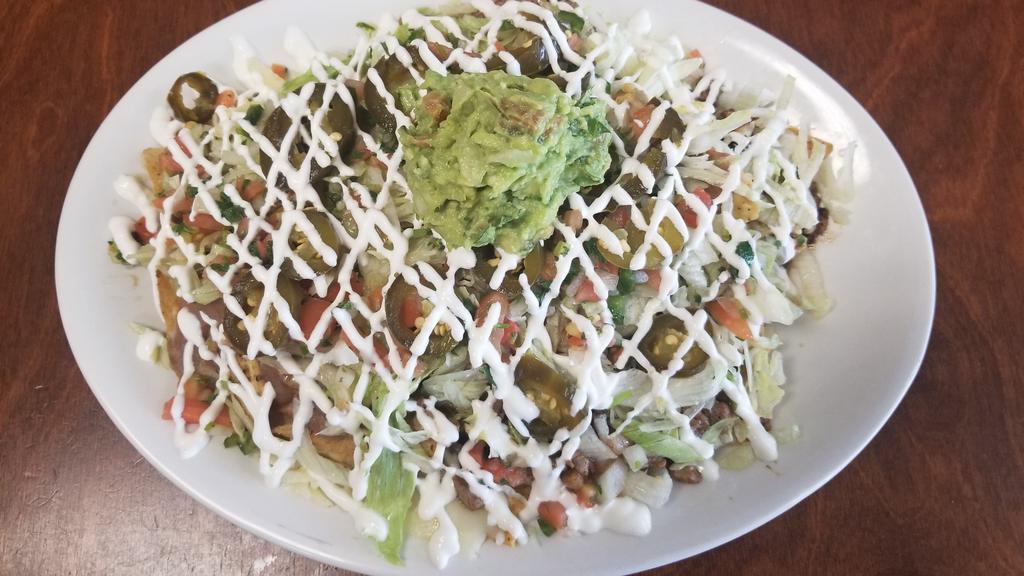 Big Nachos · Tortilla chips with melted mozzarella cheese, pinto beans, lettuce, pico de gallo, guacamole sour cream, jalapeño peppers and ,
your choice of meat,