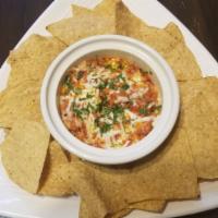 Choriqueso W Chips · Sauted Mexican sausage with onion, covered with melted cheese and cilantro topping. Served w...