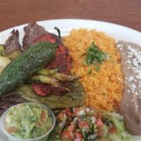 Carne Asada Plate · Charbroiled skirt steak. Served with Mexican rice, refried beans, lettuce, pico de gallo, gu...