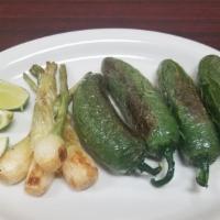 Cebollitas Y Chiles Toreados · 4Grilled chambray onions and peppers limes.