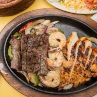 Mixed Grill · Grilled combination of shrimp, chicken, and steak fajitas with bell peppers and onions.