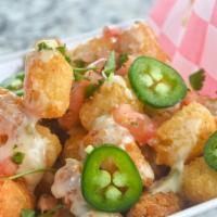 Loaded Southwest Tots · Crispy Tator Tots topped with a layer of Queso, Pico De Gallo & Minced Jalapeños