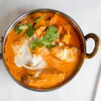 Butter Chicken · Chicken barbecued in our tandoor, simmered in a creamy, onion and tomato sauce, with herbs a...