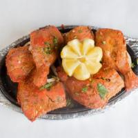 Tandoori Chicken · Whole tender spring chicken marinated in mild spices, fresh herbs, and cooked in the clay ov...