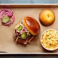 Hog Wild Sandwich · Slow-smoked juicy pulled pork piled high with tangy coleslaw, pickled jalapenos, and BBQ sou...