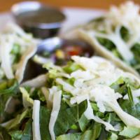 Soft Shell Tacos · Soft corn tortillas filled with spicy gardein, lettuce, cilantro, onion and cheese. Served w...