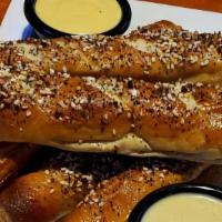 Everything Soft Pretzels · Served with Merkts cheese sauce and honey beer mustard sauce. Sprinkled with garlic, onion, ...