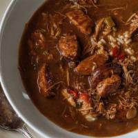 Chicken+Andouille Gumbo · Made from scratch, a cup of our classic dark roux gumbo served with rice.