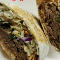 Korean Bulgogi Beef Wrap · Slow roasted pulled beef with fresh slaw, cilantro, cheddar jack cheese, spicy rice noodles ...