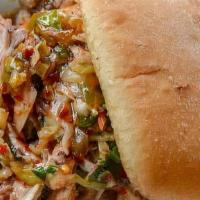 Volcano Pulled Pork Sandwich · Spicy slow roasted pulled pork topped w/cilantro lime jalapeno slaw on toasted ciabatta bun.