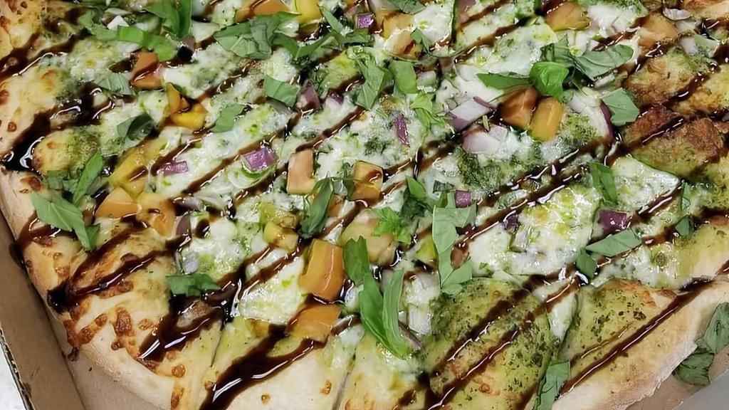 Large The Margherita Pizza · Basil pesto sauce with mozzarella cheese, tomatoes, red onions and fresh basil drizzled with balsamic reduction.