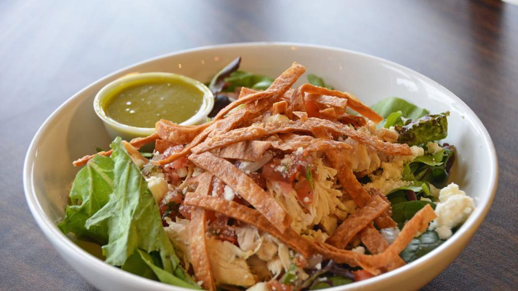 Cilantro Lime Chicken Salad · Organic greens, pulled chicken, feta and parmesan cheese, pico de gallo topped with cilantro lime dressing and tortilla chips.