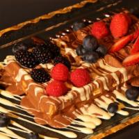Berries Waffle · Crispy waffle topped strawberries, raspberry, blueberry and blackberry drizzled with three B...