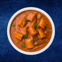 Garnish Paneer Masala · Fresh cottage cheese cubes simmered in a thick, tangy tomato and onion masala gravy