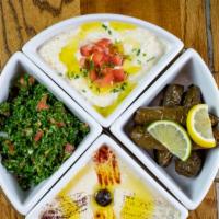 Cold Combination (V)  · A combination of Tabouli, Hummus, 4 pieces of Grape Leaves and Baba ghanoush. Served with pi...