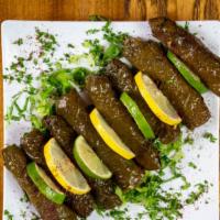 Grape Leaves (V) 8 Pieces · Grape leaves, filled with rice, seasoned with fresh dill, and mint.