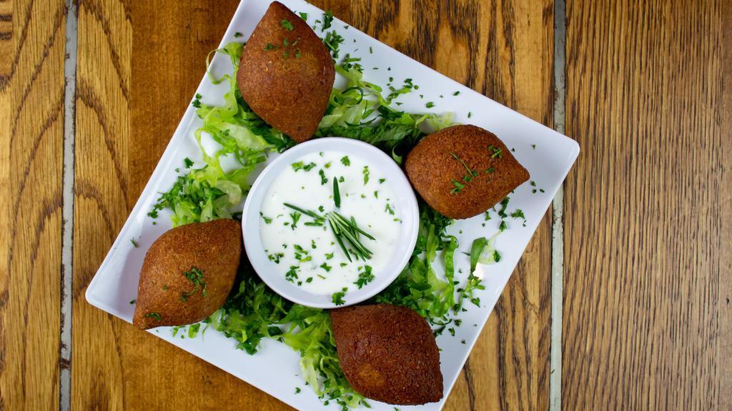 Lebanese Beef Croquettes (Kibbeh) · Ground beef, groats, onions, Pine nuts, made into balls and deep fried.