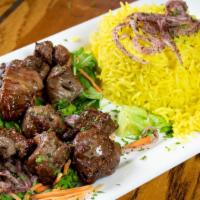 Lamb Kabab Plate · Two skewers of lamb cubes marinated with Arabic spices. Served with rice, and a side of salad.