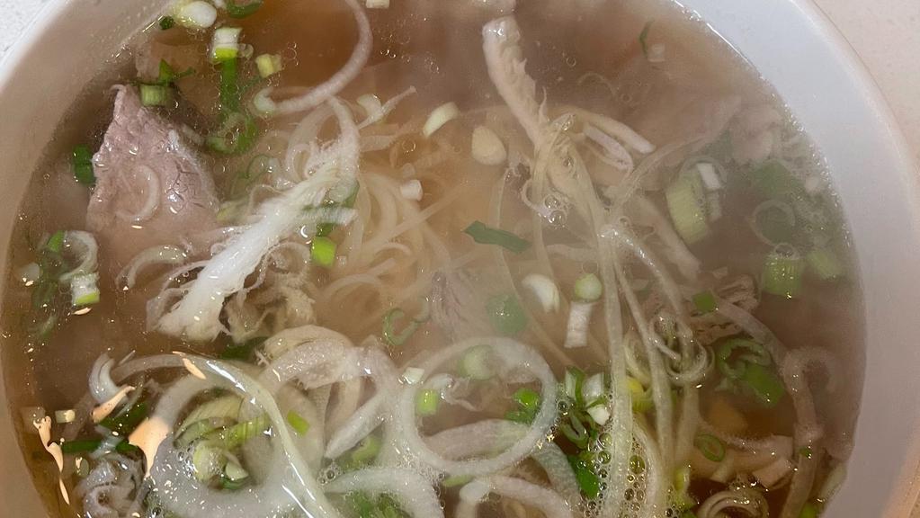 Combination Pho · Meatball, Rare  beef, tendon and brisket. Traditional beef soup with rice noodle served with a side of bean sprouts, Thai basil, jalapeno peppers and a wedge of lime.